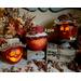 A trio of fall apple gourd decorations. Each has a happy face carved into the shell and a custom hat. Their names are Cora, Apple, and Mac.